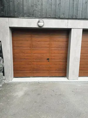a pair of wooden garage doors on a building at Sentral leilighetshytte 16A in Stranda