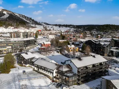 an aerial view of a town with snow covered buildings at Geilo Town Centre - Apartment with a Superb Location and walking Distance to Everything in Geilo