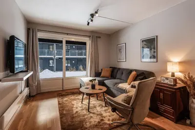 a living room with a couch and a table at Geilo Town Centre - Apartment with a Superb Location and walking Distance to Everything in Geilo