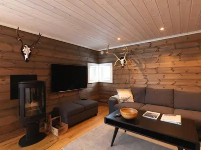 a living room with a couch and a flat screen tv at Stranda Fjellgrend 3 bedrooms - 12A in Stranda