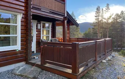 a porch of a log cabin with a window at Pet Friendly Home In Lesjaskog With Wifi in Bjorli