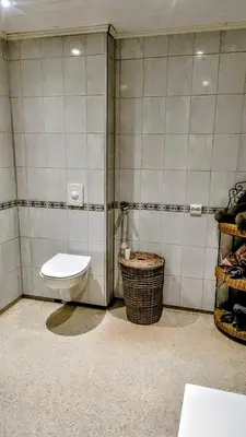 a bathroom with a toilet and a glass shower at Skap Opplevelser! in Svingvoll