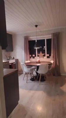 a kitchen and dining room with a table and chairs at Skap Opplevelser! in Svingvoll