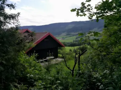 a small house in the middle of a field at Skap Opplevelser! in Svingvoll