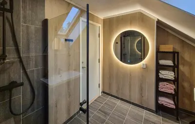 a bathroom with a shower and a mirror at Beautiful Home In Bøvågen With Sauna in Bøvågen