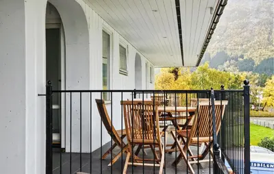 a porch with a table and chairs on a balcony at 3 Bedroom Lovely Apartment In Eidfjord in Eidfjord