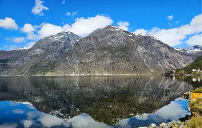 a mountain reflection in a lake with mountains in the background at 3 Bedroom Lovely Apartment In Eidfjord in Eidfjord