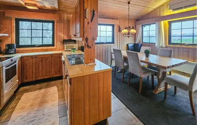 a kitchen and dining room with a table in a cabin at Awesome Home In Hemsedal With Sauna in Hemsedal