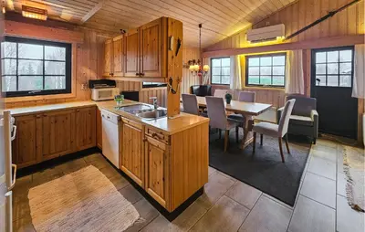 a kitchen and dining room with a table and chairs at Awesome Home In Hemsedal With Sauna in Hemsedal