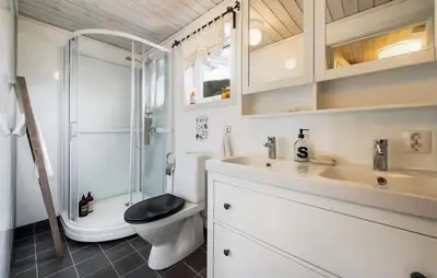 a bathroom with a shower and a toilet and a sink at 3 Bedroom Awesome Home In Strandebarm in Strandebarm