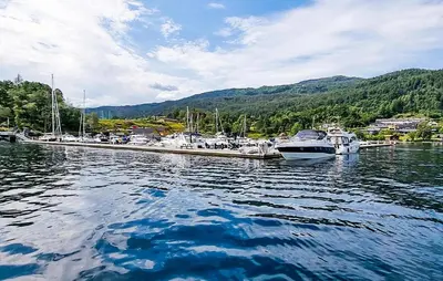 a group of boats docked at a dock in the water at 3 Bedroom Awesome Home In Strandebarm in Strandebarm