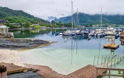a bunch of boats are docked in a harbor at 3 Bedroom Awesome Home In Strandebarm in Strandebarm