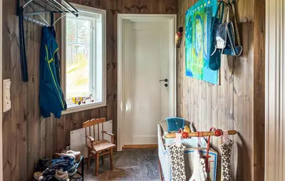 a room with a chair and a door and a window at Stunning Home In Røros With Sauna in Røros