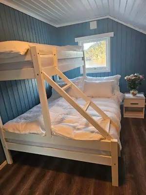 a bunk bed in a room with blue walls at Furiholmen in Askøy