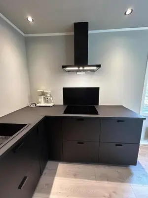 a kitchen with a black counter top and a stove at Villa Isfjorden in Isfjorden