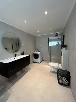 a bathroom with a sink and a toilet and a mirror at Villa Isfjorden in Isfjorden