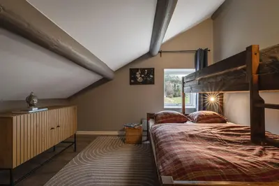 a bedroom with a bunk bed and a window at Spacious Hemsedal home with ski slope view in Hemsedal