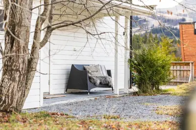 a porch with a chair sitting outside of a house at Spacious Hemsedal home with ski slope view in Hemsedal