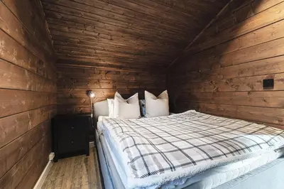a bedroom with a bed in a wooden cabin at Unique 'Stabbur' in Hemsedal, view to skislopes in Hemsedal