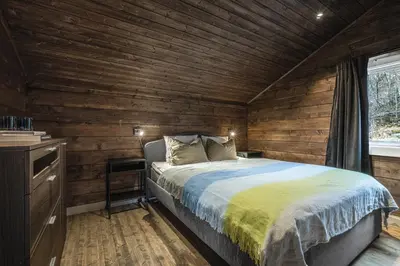 a bedroom with a bed in a wooden cabin at Unique 'Stabbur' in Hemsedal, view to skislopes in Hemsedal
