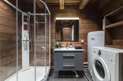 a bathroom with a sink and a washing machine at Unique 'Stabbur' in Hemsedal, view to skislopes in Hemsedal