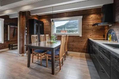 a kitchen with a table and chairs and a window at Unique 'Stabbur' in Hemsedal, view to skislopes in Hemsedal