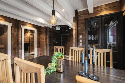 a dining room with a wooden table and chairs at Unique 'Stabbur' in Hemsedal, view to skislopes in Hemsedal