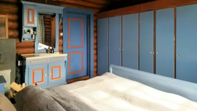 a bedroom with a bed and a mirror at Historic Cabin From 1906 In Sjusjøen in Sjusjøen