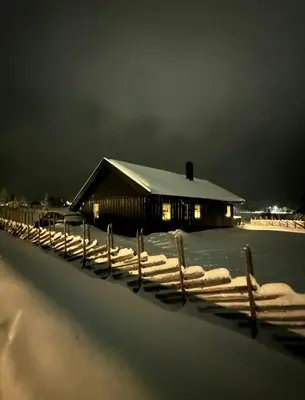 a barn covered in snow in front of a fence at Sunny Cabin With Panoramic Views At Golsfjellet in Tisleidalen