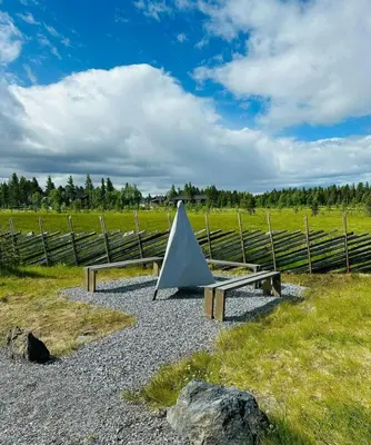 a tent sitting on two benches in a field at Sunny Cabin With Panoramic Views At Golsfjellet in Tisleidalen