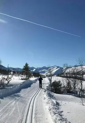 a person is skiing down a snow covered slope at Charming Mountain Cabin In Spectacular Nature in Brunstad