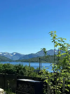 a view of a lake with mountains in the background at Charming Mountain Cabin In Spectacular Nature in Brunstad