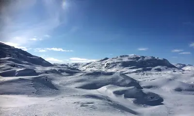 a mountain covered in snow with the sky in the background at Log Cabin By Hardangervidda National Park in Nesland