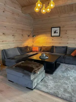 a living room with a couch and a coffee table at Large Dream Cabin On Vegglifjell in Veggli