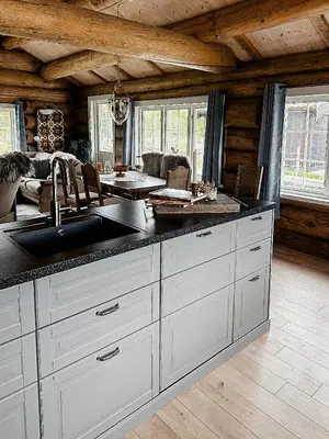 a kitchen with a sink and a counter top at Modern Hand-Crafted Log Cabin in Dovreskogen