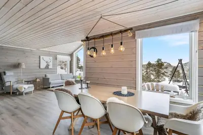 a dining room with a table and chairs at Modern Cabin Near Maldalsvatnet And Reinsnuten in Sauda
