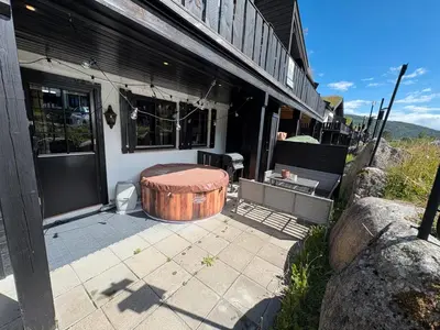 a porch of a house with a wooden table on it at Norefri - Norefjell in Noresund