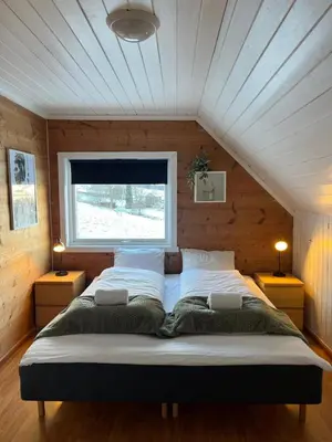 a large bed in a room with a window at Panoramic mountain views, space for the whole family in Vossevangen