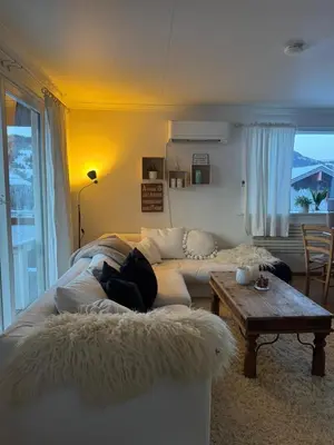 a living room with a couch and a table at Panoramic mountain views, space for the whole family in Vossevangen
