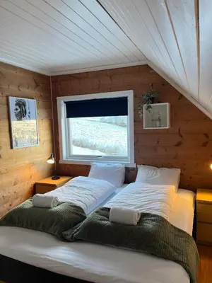 a bed in a room with a window at Panoramic mountain views, space for the whole family in Vossevangen