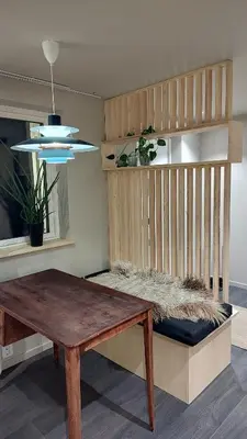 a room with a wooden bench and a table at Splitter ny leilighet i sokkel på enebolig in Vikhammer