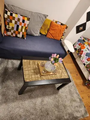 a living room with a couch and a table at Nice Apartment in Sjetnemarka - Free parking and WiFi in Trondheim