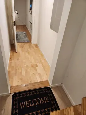 a welcome mat on the floor of a hallway at Nice Apartment in Sjetnemarka - Free parking and WiFi in Trondheim