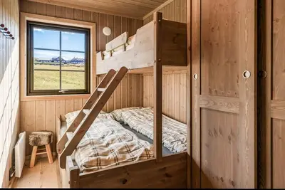 a bunk bed in a cabin with a window at New Cabin With Views Of Tisleiefjorden in Gol