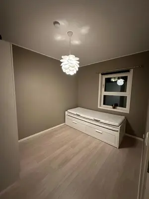 an empty room with a window and a chandelier at Great apartment in Bergen! in Lii