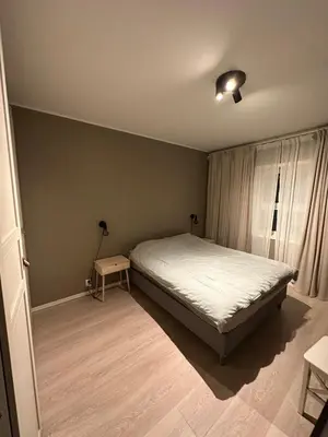 a small bedroom with a bed and a window at Great apartment in Bergen! in Lii