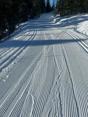 a road covered in snow with ski tracks at Family Cabin From 1968 At Norefjell in Noresund