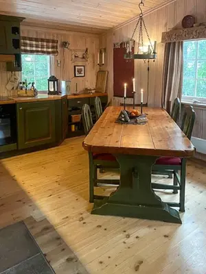 a kitchen with a wooden table with candles on it at Family Cabin From 1968 At Norefjell in Noresund