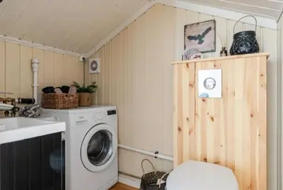 a laundry room with a washing machine and a sink at Cabin With Ski-Inout And Hot Tub In Fageråsen in Trysil