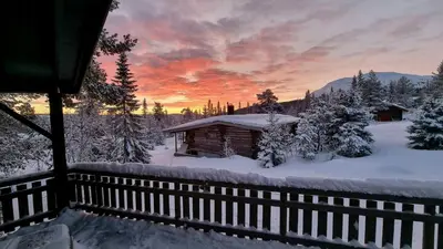 a cabin in the snow with a sunset at Cabin With Ski-Inout And Hot Tub In Fageråsen in Trysil